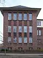Ansicht der Fassade mit bildhauerischen, themenbezogenen Elementen am Humboldt-Gymnasium in Eichwalde