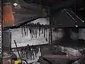 Esse mit Blasebalg in einer alten Schmiedewerkstatt