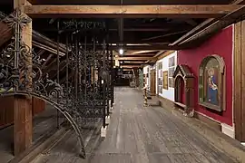 Die Wände im Schaulager sind in liturgischen Farben gehalten. Links das Chorgitter von 1891, 2019