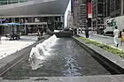 Brunnen und Pflasterung vor dem Gebäude