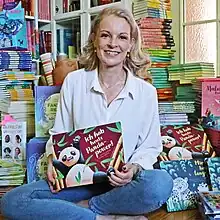 Schütze in ihrem Arbeitszimmer vor Bücherstapeln
