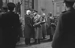 Links in Zivil Carl Oberg im Gespräch mit Standartenführer Griese, dahinter General Felber, der eine Meldung entgegennimmt