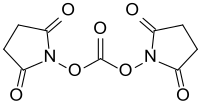 Strukturformel von N,N′-Disuccinimidylcarbonat