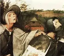 Der Bildausschnitt zeigt jeweils Oberkörper und Kopf des dritten (rechts) und des vierten Blinden, im Hintergrund den Hügel und davor ein Bauernhaus. Der linke hat die Hand auf die Schulter des vor ihm Gehenden gelegt. Er trägt einen hellen Umhang über einem ledernen Wams und einen Hut über einer weißen Stoffhaube. Er hat das bartlose Gesicht mit halb geöffnetem Mund nach oben gerichtet. Der rechte hat einen Umhang mit schwarzer Passe über die dunkle Weste geworfen. Er hat einen schwarzen Dreitagebart, unter der dunklen Haube tritt schwarzes, kurzes Haar hervor. Die Darstellung der Augen der Beiden ist so präzise, dass Experten beim Linken ein Glaukom und beim Rechten schwarzen Star diagnostizieren konnten.