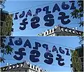 Eine praktische Anwendung eines Ambigramms in einem weniger windanfälligen Transparent für das Idaplatz-Quartierfest in Zürich 2008 (Spiegelbilder)