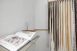Textilfoyer im Gemeindehaus mit Stoffmustern und einer Enzyklopädie zur Textilherstellung