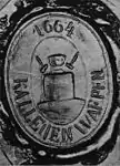 Siegelabdruck mit Hämmern und Amboss im Wappen des Dorfes Kalējciems (Schmiede) der „Kurischen Könige“.