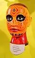 Gesichtsbemalung („face writing“) zur rituellen Darstellung der Gottheit Muthappan
