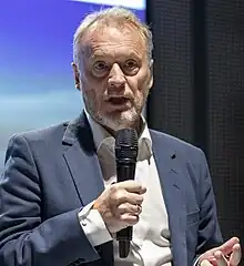 Foto eines Mannes, der in ein Mikrofon spricht