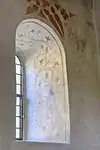 Verziertes Fenstergewände, daneben die heilige Barbara