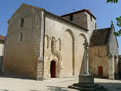 Ortskirche Notre-Dame de l'Assomption mit Steinkreuz und Eingangsportal auf der Südseite
