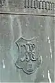 Gießerzeichen zwei verschlungene Buchstaben R und E