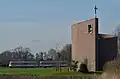 Auf dem Weg zur "Sünne-Peider-Kirmes" nach Versmold passiert der MAN-Schienenbus im Februar 2014 die markante Kapelle bei Müschen.