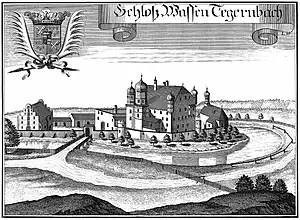 Michael Wening: „Schloß Wasentegernbach“ um 1715; im Bild links oben: Wappen der Fürstpropstei Berchtesgaden mit Mittelschild des langjährigen Fürstpropstes bzw. kurkölnischen Administrators der Fürstpropstei Joseph Clemens von Bayern rechts: Kirche St. Johannes von Süden