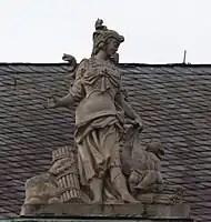 50. Militärwesen – Kriegerin, Putto, Stockbündel.