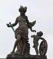 55. Justitia (Gerechtigkeit) – Putto, Richtschwert, Richtrad.