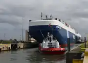 Autotransporter mit Schleppern in der Schleuse