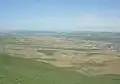 Tal des Flusses Pirsaat mit dem Dorf Birinci Udullu im Norden des Rajons. Am Horizont die schneebedeckten Gipfel des Großen Kaukasus jenseits Şamaxı