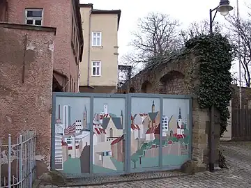 Nördliche Mauerreste der Reichsburg an der einsti­gen Kutschenstation von 1563, Burggasse 17 (vorne links, heute restauriert) mit zuge­mauer­ten, raumhohen Öffnungen. Blick von außen auf die Burgmauer