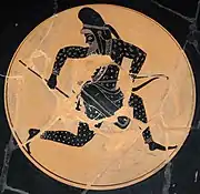 Skythischer Bogenschütze auf einer schwarzfigurigen, attischen Kylix, ca. 530 bis 520 v.&nbsp;C. Die Nackenlasche seiner Mütze ist hinter das Stirnband hochgesteckt.