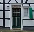 Haustür mit Türinschrift in Kleinenberg