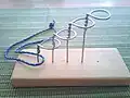 Ineinandergreifendes lineares Ringpuzzle analog den chinesischen Ringen. Exponentielle Anzahl von Lösungsschritten entsprechend der Ringanzahl.