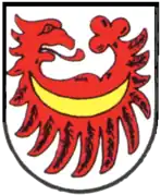 Auf großen Federn nach unten gekehrter querliegender Adlerflug, mit nach links gekehrten Adlerkopf und hinten mit Kleeblatt (Heinsheim)