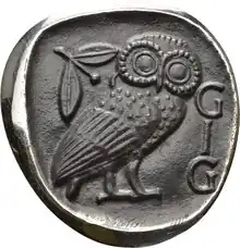 Emblem der GIG auf der Basis einer attischen Tetradrachme (ca. 430 v. Chr.) mit den Initialen der Gesellschaft